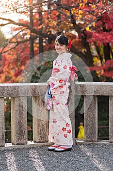 Young woman tourist wearing kimono enjoying with colorful leaves in Kiyomizu dera temple, Kyoto, Japan. Asian girl with hair style