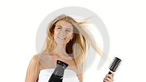Young woman with towel holding blow dryer. slow