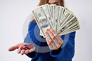 Young woman with a toy car and money in hand