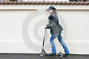 Young woman with toy scooter