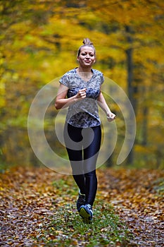 Young woman trail running in the forest