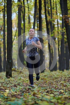 Young woman trail running in the forest