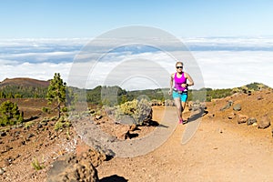 Young woman trail running in mountains