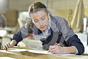 Young woman trainee in carpentry designing