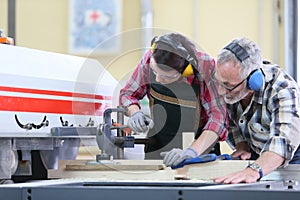 Young woman trainee in carpentry workshop