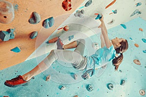 Young woman training in climbing gym