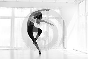 Young Woman Training Contemp In Modern Dance Studio. Black And W