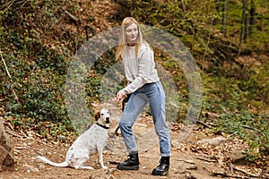 Young woman training her pet dog