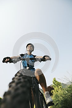 Young woman training on mountain bike and cycling in park