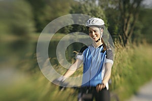 Young woman training on mountain bike and cycling in park