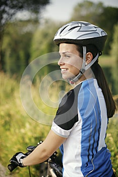 Young woman training on mountain bike and cycling in park