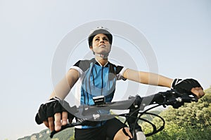 Young woman training on mountain bike and cycling in park