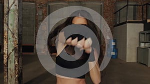 Young woman training portrait punch boxing gloves for punching. Girl making Strong kick. CrossFit. Female boxer woman