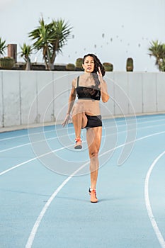 Young woman training on track athletics