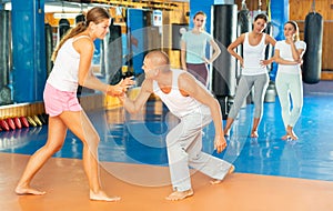 Young woman training wristlock movement