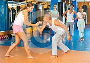 Young woman training wristlock movement