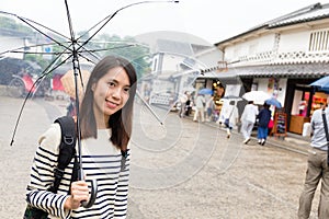 Young woman travel in japan with raining