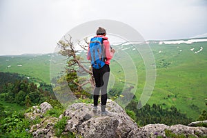 Young Woman Traveler with Backpack hiking in Mountains with beau