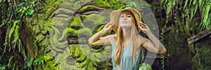 Young woman traveler in a Balinese garden overgrown with moss. Travel to Bali concept BANNER, LONG FORMAT