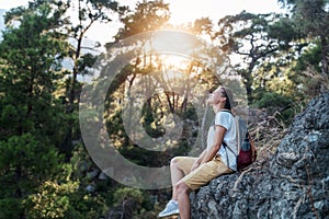 Young woman traveler in the forest and enjoying for beautiful view of nature on holiday. Adventure concept