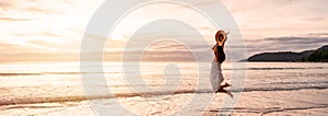 Young woman traveler jumping and enjoying beautiful Sunset on the tranquil beach, Travel on summer vacation concept