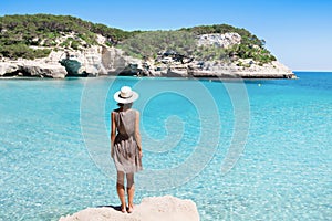 Young woman traveler looking at the sea, travel and active lifestyle concept. Relaxation and vacations concept.