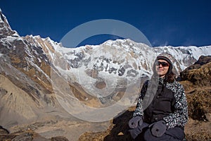 Young woman traveler sitting in front of Himalaya mountains