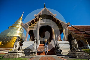 Young woman traveler traveling to Wat Phra Singh temple. This te