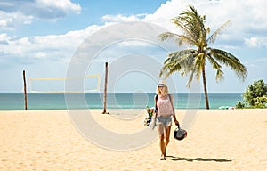 Young woman traveler walking on the beach in Phuket island