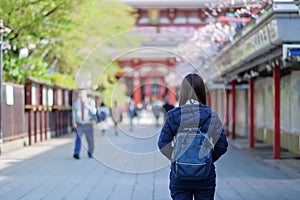 Young Woman traveling backpacker, Asian traveler standing at Sensoji or Asakusa Kannon Temple. landmark and popular for tourist at