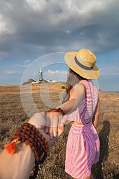 young woman is traveling through the countryside with her man when they stumble upon a field with a lighthouse. Free