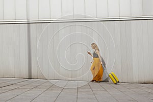 Young woman traveling with her suitcase and looking for an apart