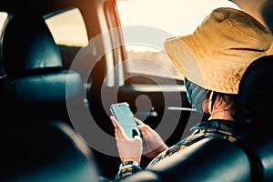 Young woman traveling on holiday with the car and wearing the mask