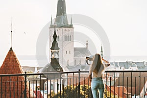 Young woman traveling in Tallinn city vacations in Estonia