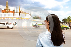 Young Woman traveling to Grand palace and Wat Phra Keaw at sunset at Bangkok, Thailand