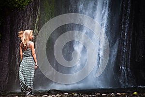 Young woman traveling to waterfall