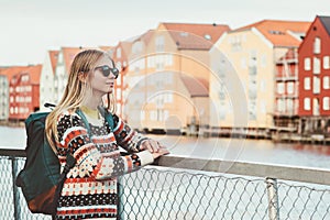 Young woman traveling in Trondheim city Norway vacations weekend Lifestyle fashion outdoor scandinavian houses landmarks architect