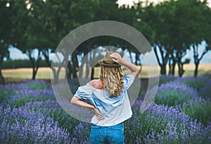 Young woman traveller standing in lavender field, Isparta, Turkey