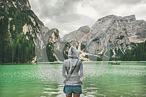 Young woman traveller standing and looking at Lago di Braies