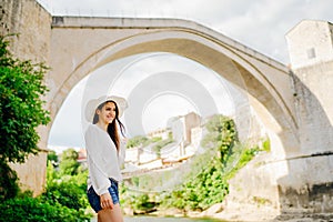 Young woman traveller visiting popular tourist destinations in Southeast Europe,Old Bridge landmark in Mostar,Bosnia and