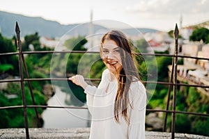 Young woman traveller visiting popular tourist destinations in Southeast Europe,Old Bridge landmark in Mostar,Bosnia and