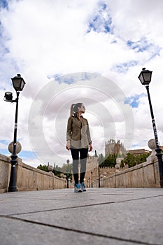 Young woman traveller walking through a bridge during a antumn afternoon