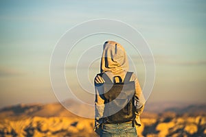 Young woman traveller watching sunrise in Goreme, Cappadocia, Central Turkey