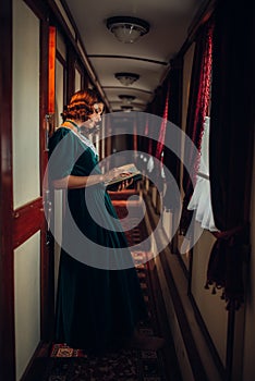 Young woman travels, vintage train compartment