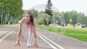 Young woman on a treadmill ready to run. Caucasian fitness girl during workout