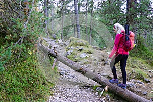 Young woman trekking on the Adolf Munkel Trail in the Dolomites.
