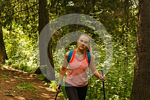 Young woman trekking in a mountain forest