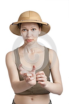 Young woman in a tropical helmet showing by fingers small size