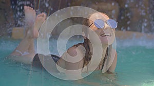 A young woman in a tropical resort with hot springs, waterfalls and swimming pools with hot mineral water
