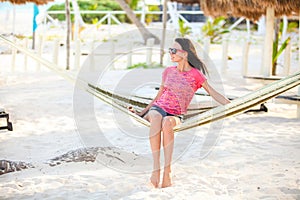 Young woman on tropical vacation relaxing in